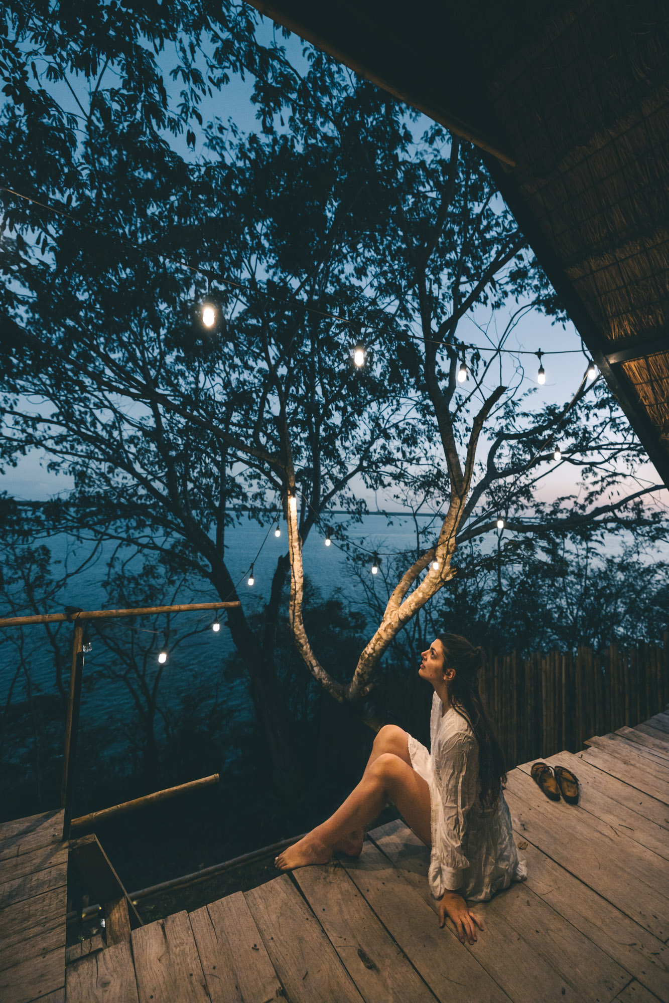 Woman enjoying the balcony view at Azul Nomeolvides Hotel in Bacalar, Mexico