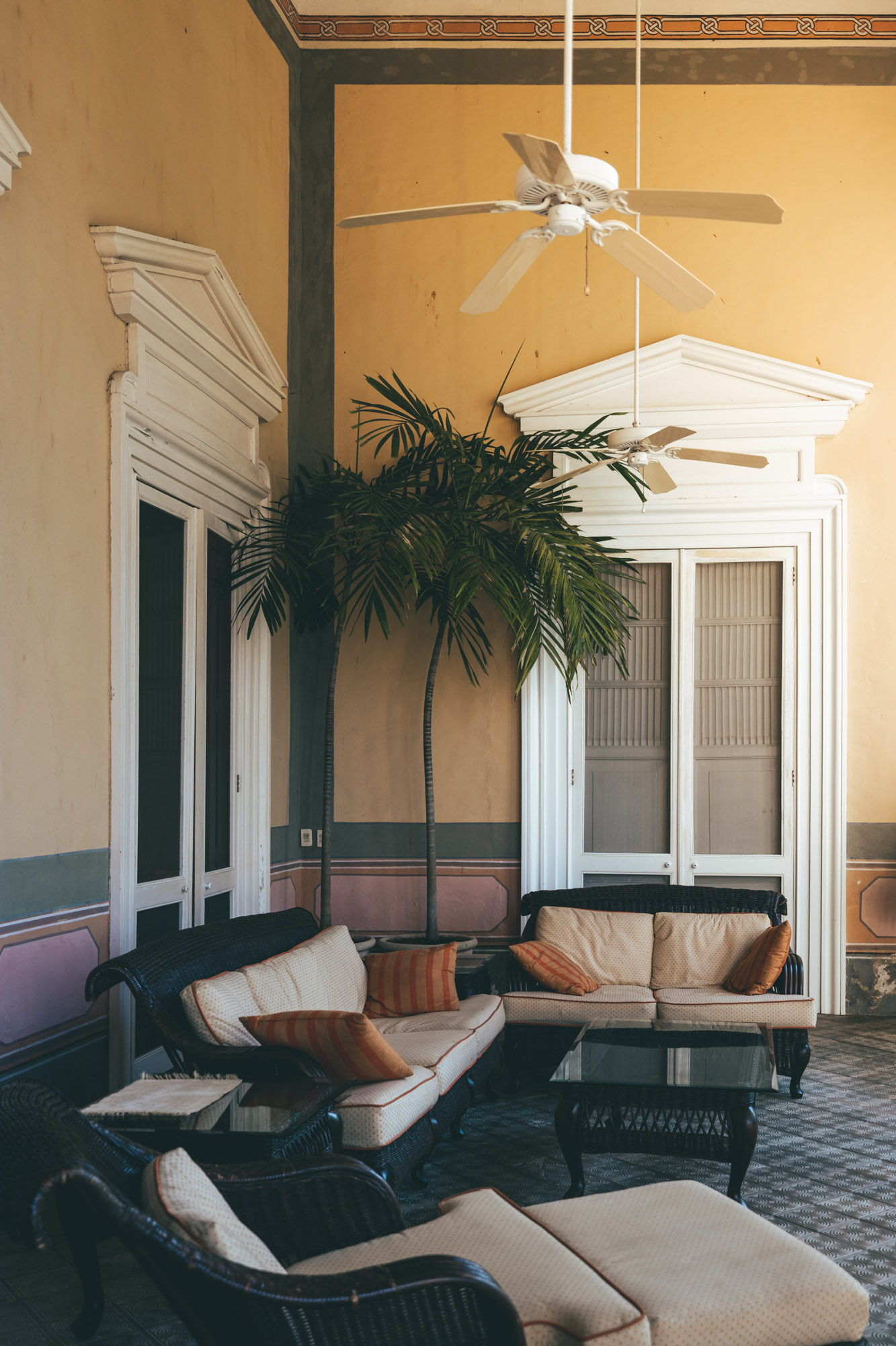 Elegant colonial-style lounge with rattan furniture at Hacienda San Antonio Millet, Merida, Mexico