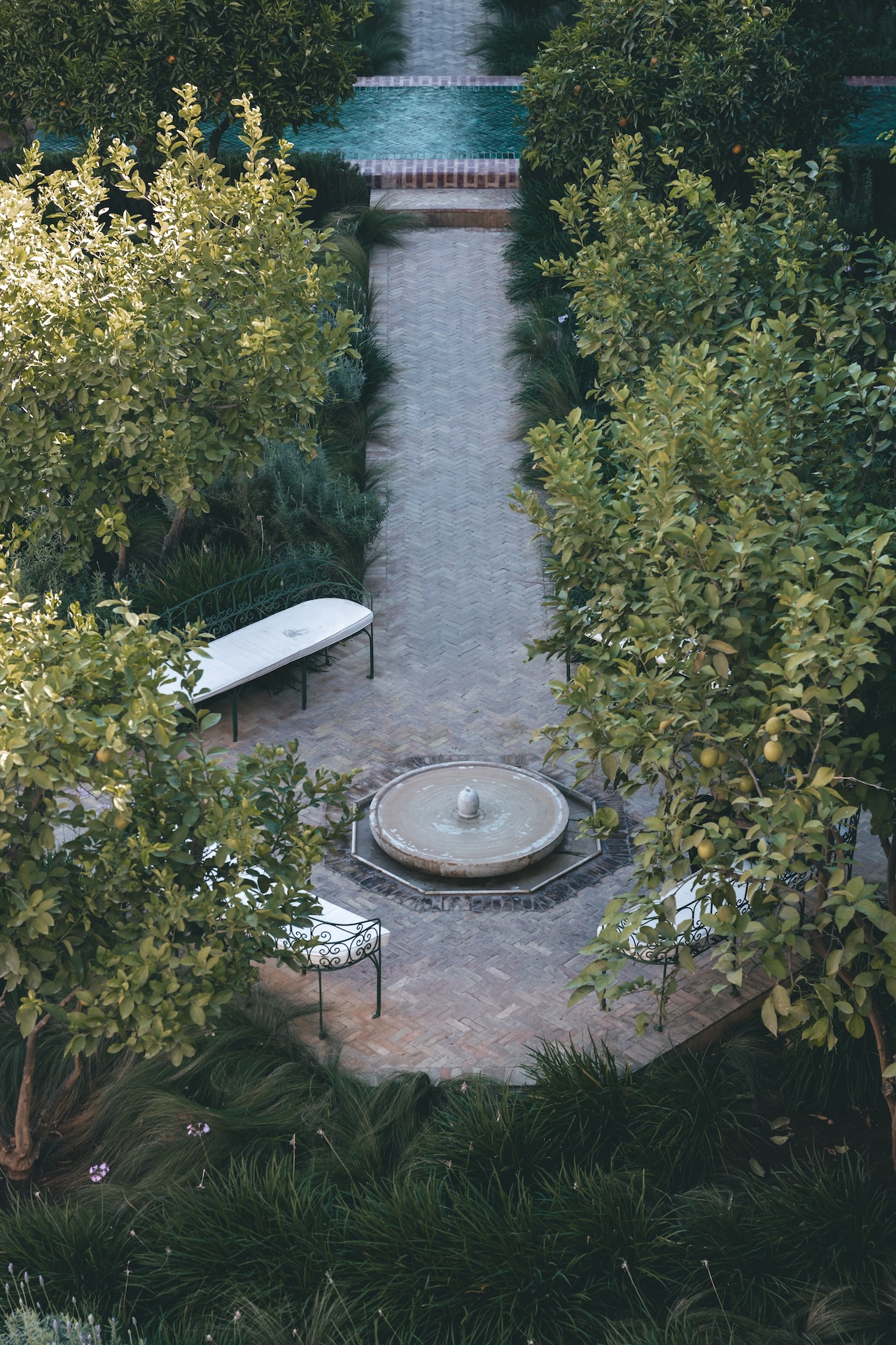 Tranquil garden pathway with a fountain at Le Jardin Secret, Marrakech, Morocco