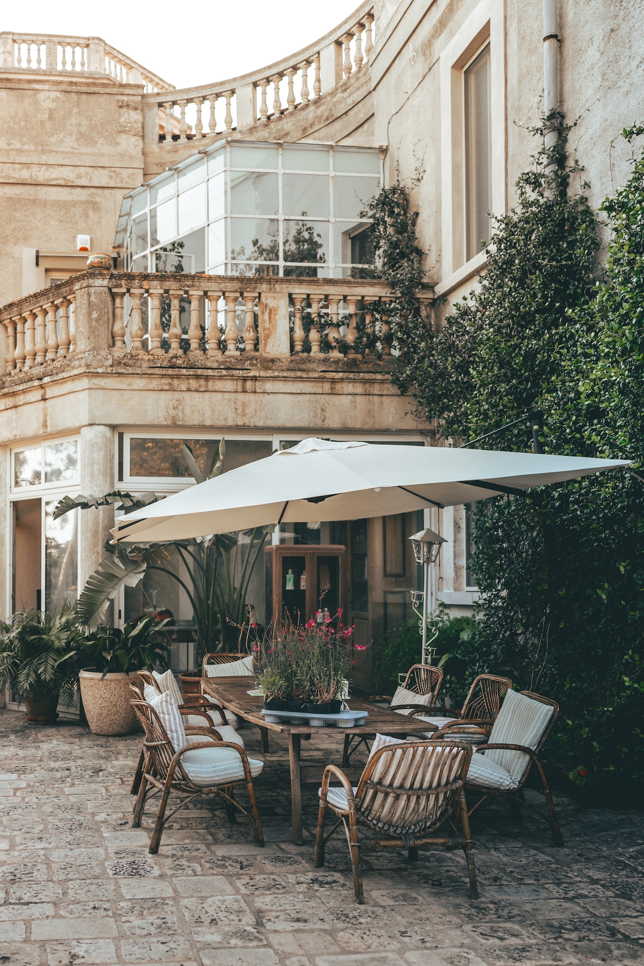 Outdoor seating area with umbrellas at Villa Rosa Resort in Conversano, Italy