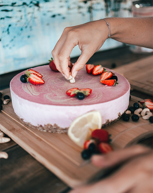 Chef Maddie in the midst of perfecting a plant-based cake with delicate touches, emphasizing the art of vegan baking in Fuerteventura