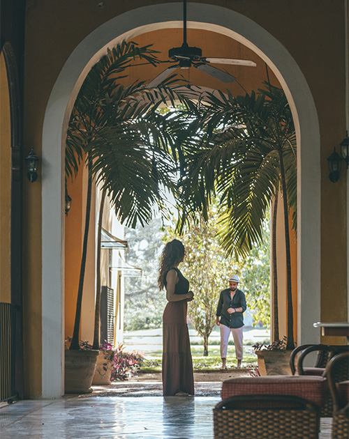 A moment of conversation under the arches surrounded by the verdant flora at Hacienda San Antonio Millet