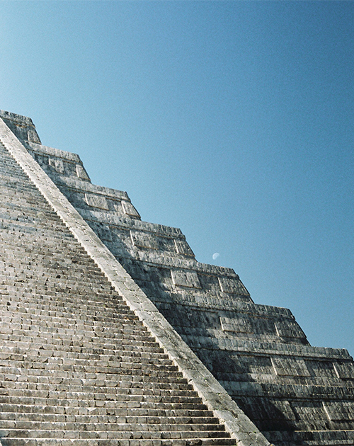 Moonrise behind the ancient Mayan Pyramid of Kukulcan in Chichen Itza, Yucatan, a testament to Mexico's rich history