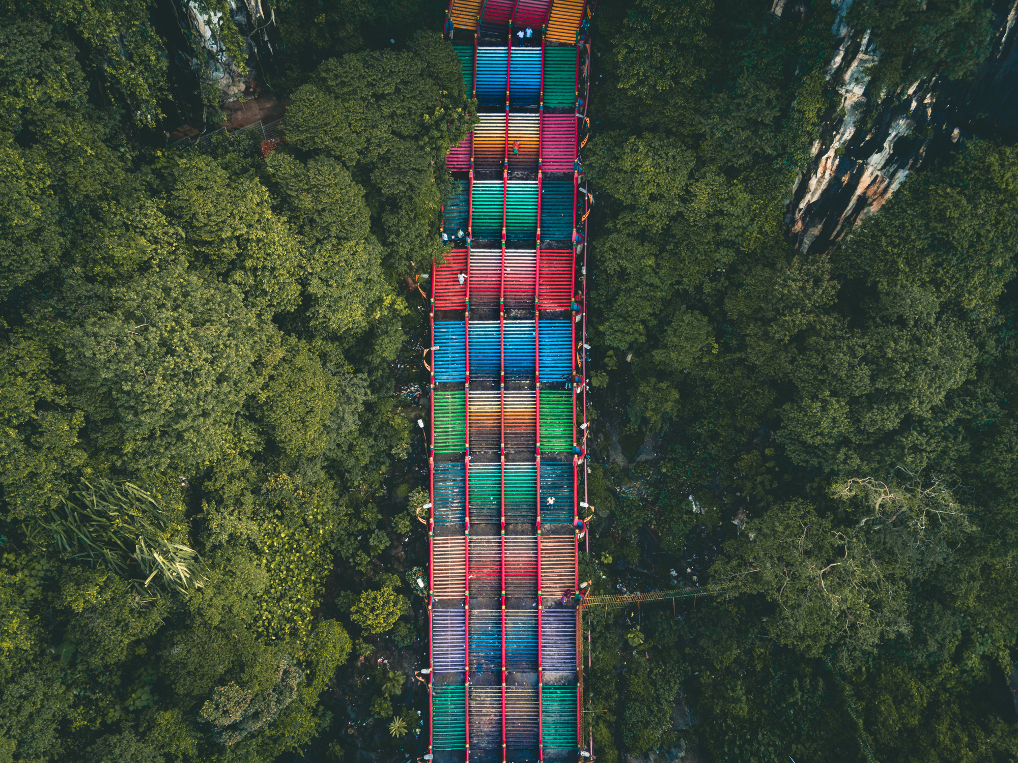 Colorful aerial view of the Batu Caves staircase in Kuala Lumpur, leading visitors to the magnificent limestone caves and temples.