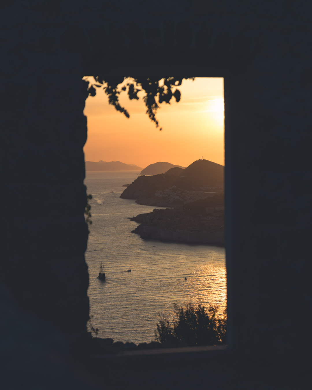 A serene sunset view framing the historic city of Dubrovnik