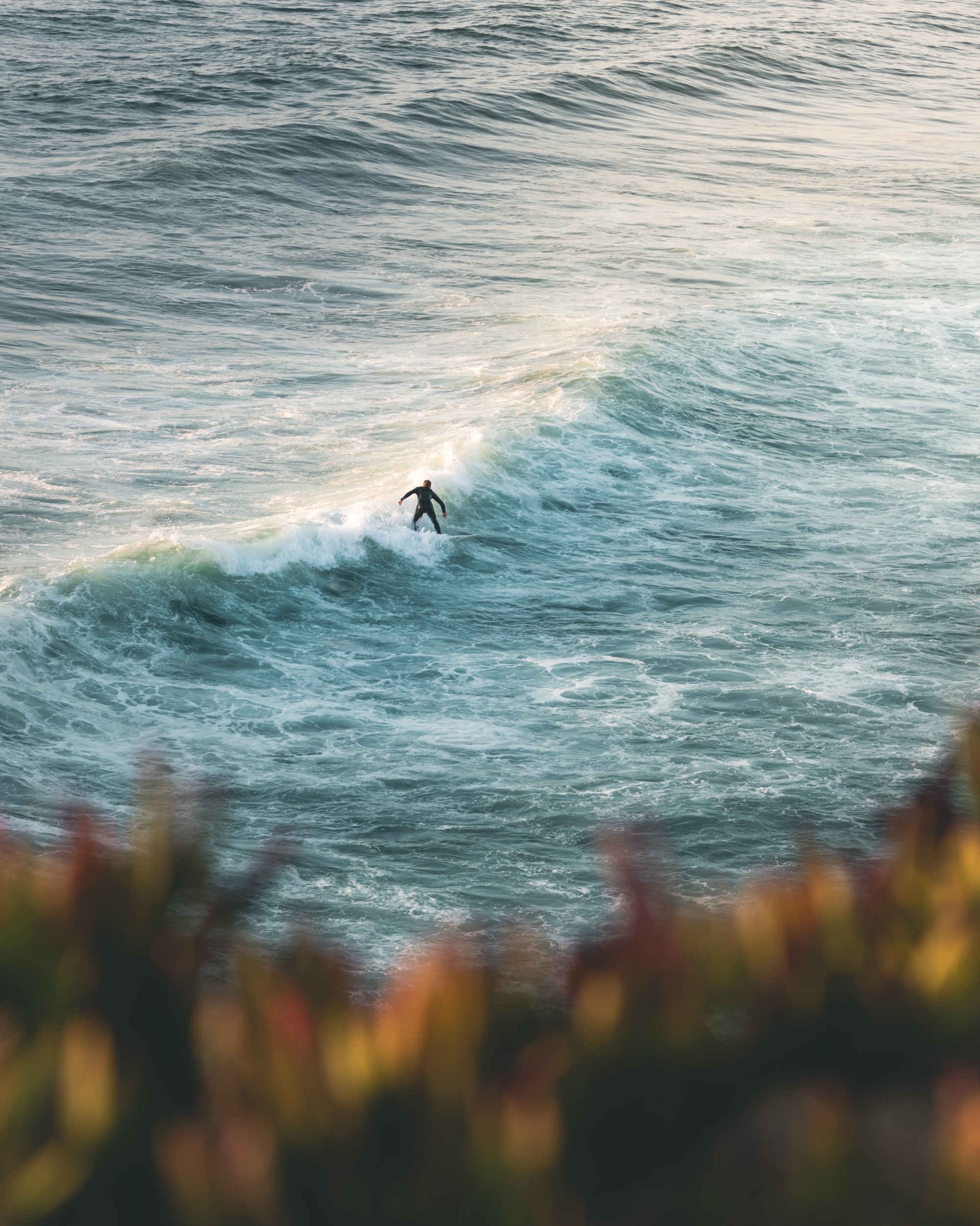 Surfer riding a wave in Aljezur, Portugal